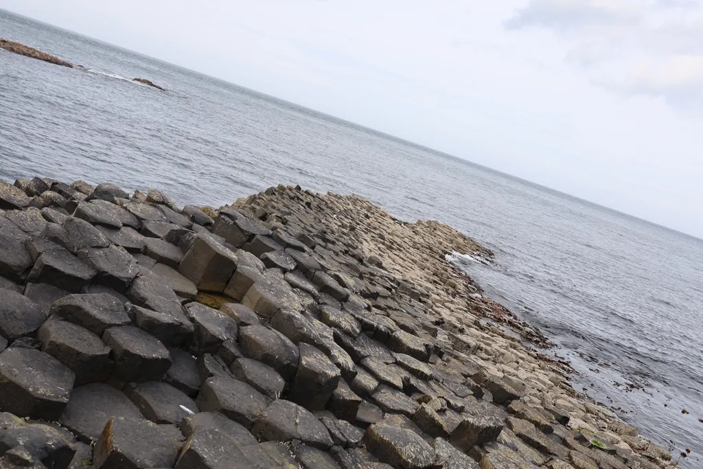 Hexagonal basalt columns running down into the sea